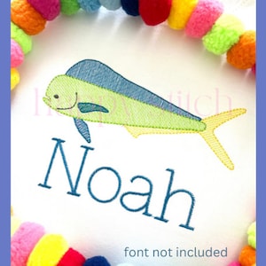 May include: Embroidered design of a green and blue fish with a yellow tail, with the name Noah embroidered below. The design is on a white background surrounded by a colorful pom-pom trim.