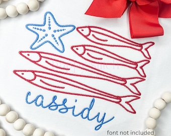 May include: White t-shirt featuring a blue starfish and red fish design. The name "cassidy" is written in blue script. A red bow is in the upper right corner, and white beads are on the top and bottom.