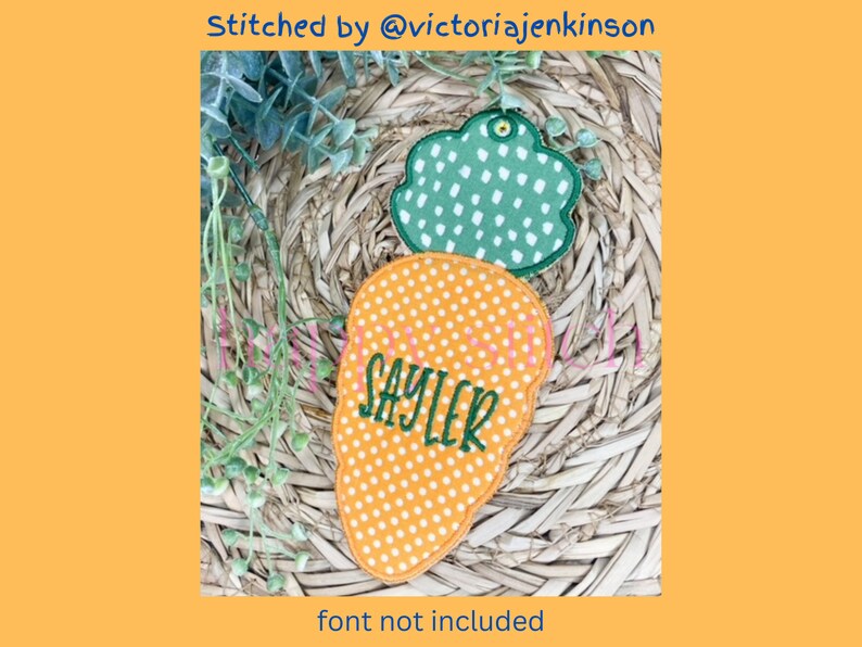 May include: An orange carrot-shaped applique with white polka dots and the name "SAYLER" embroidered in green. A green cloud-shaped applique with white polka dots is above the carrot. The text "Stitched by @victoriajenkins" is at the top.