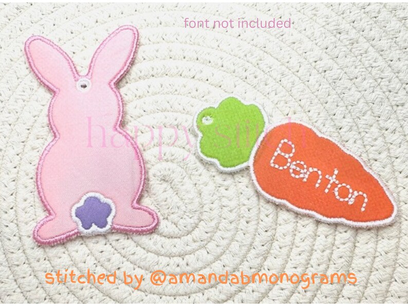 May include: A pink bunny-shaped applique with a purple tail, and a green leaf-shaped applique, next to an orange carrot applique with the name "Benton" stitched in white. The items are on a woven surface.