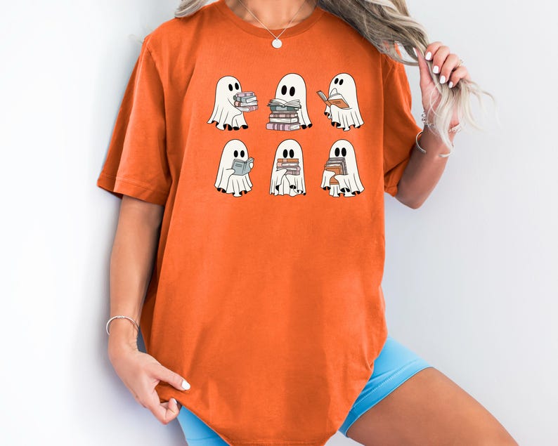 a woman wearing a t - shirt with ghost characters on it