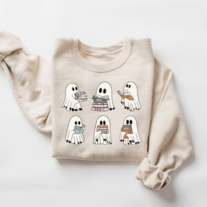a white sweater with ghost characters on it