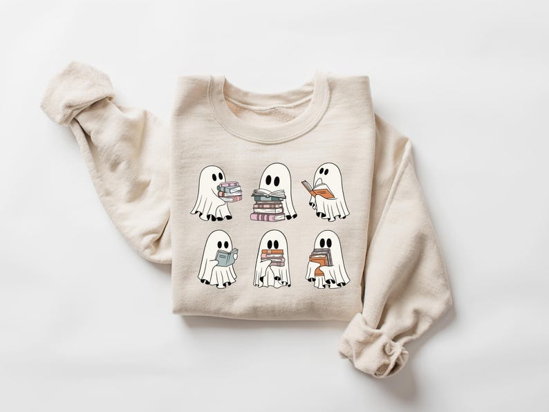 a white sweater with ghost characters on it