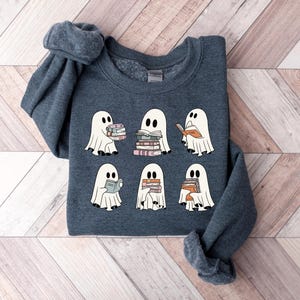 a group of ghost sweaters sitting on top of a wooden floor