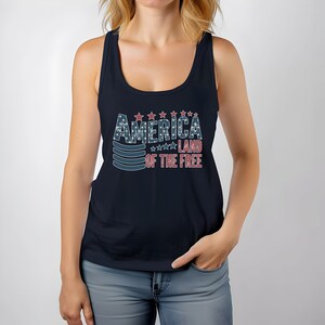 a woman wearing a tank top that says america land of the free