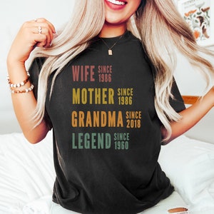 a woman with long blonde hair wearing a black shirt