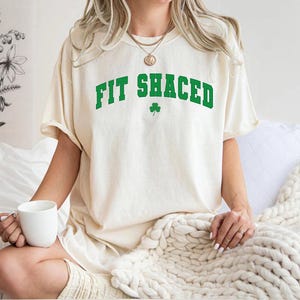 a woman sitting on a bed holding a cup of coffee