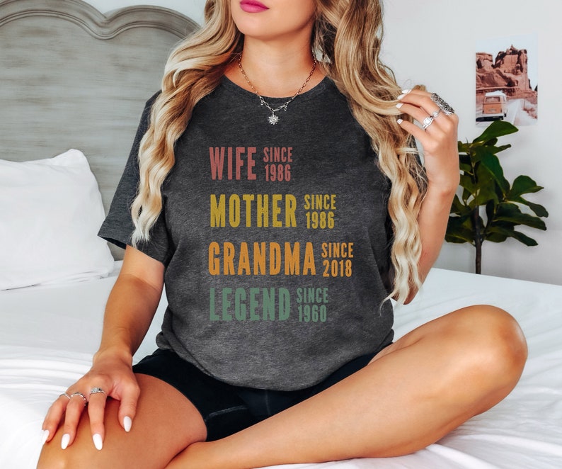 a woman sitting on a bed with her legs crossed