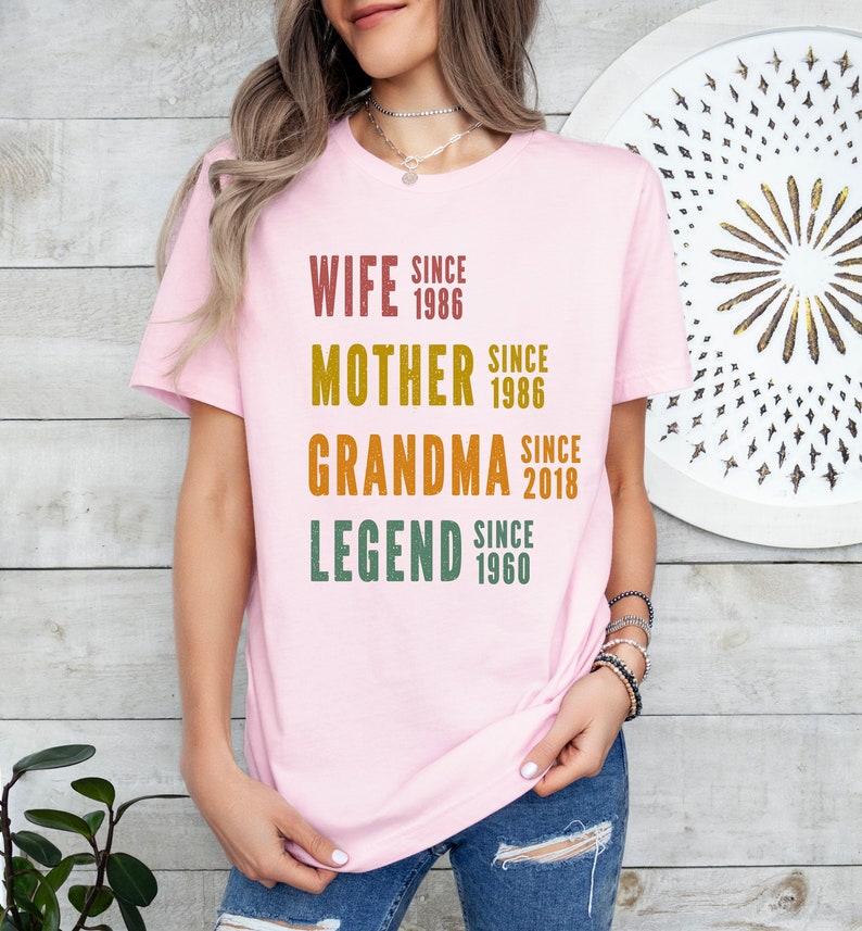 a woman wearing a pink t - shirt with the words, wife since grandma since