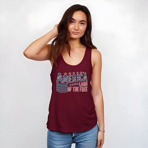 a woman wearing a tank top that says america on the front