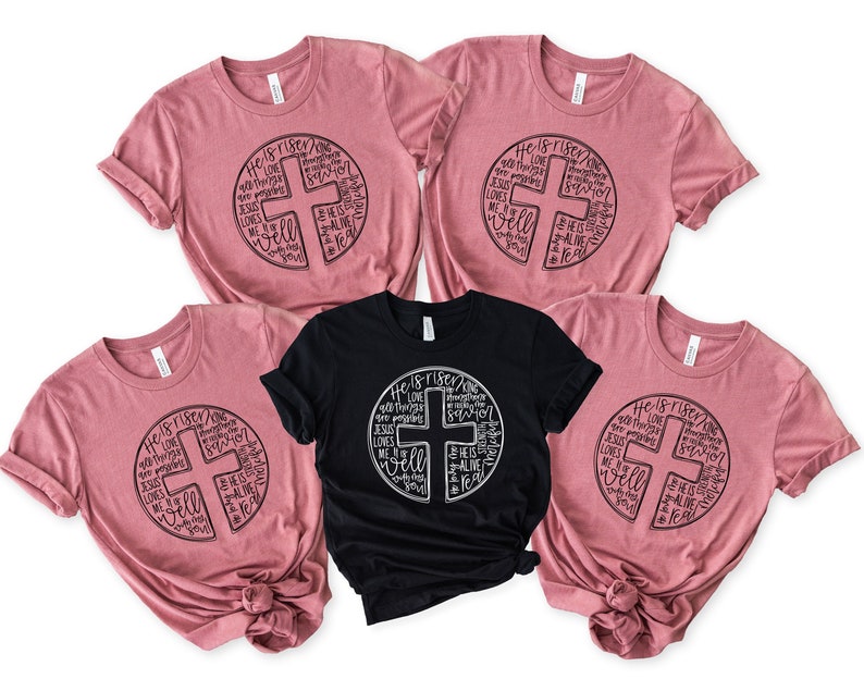 a group of pink shirts with black and white designs on them