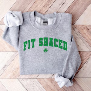 a sweatshirt with the word fit shacked printed on it