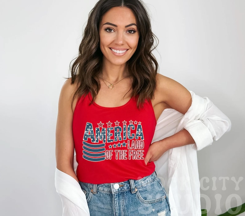 a woman wearing a red tank top with america on it