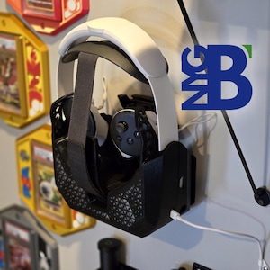 May include: A black VR headset holder with a white VR headset and controllers inside. The holder is mounted on a white wall with a white cord plugged into the headset.