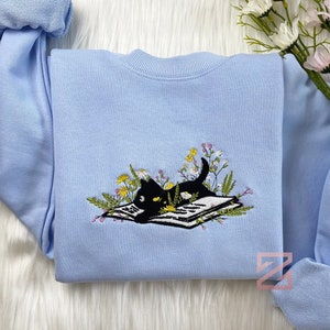 Embroidered Cute Cat Lying On Book With Flower Sweatshirt | Flower With Cat Embroidered Hoodie | Book Lover T-Shirt | Crew Neck Sweatshirt