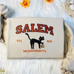 刺繍入りカボチャを持った猫のスウェットシャツ、セーラム猫のスウェットシャツ、オーバーサイズのクルーネックのスウェットシャツまたはパーカー、ユニセックスTシャツ