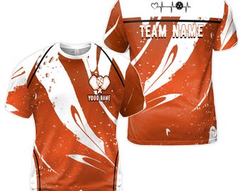 Könnte beinhalten: Orangefarbenes und weißes Sublimations-T-Shirt mit einem Paddleball-Design und dem Text "YOUR NAME" und "TEAM NAME".