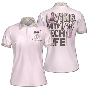 May include: Pink women's golf shirt with a plaid collar. The front of the shirt has the text "nail tech life" and "Your name". The back of the shirt has the text "Living my nail tech life" with a pink nail polish bottle graphic.