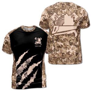 May include: Two black and tan camouflage patterned t-shirts with a white graphic of a saw, a saw blade, and a hammer. One shirt has the text "YOUR NAME" on the front.
