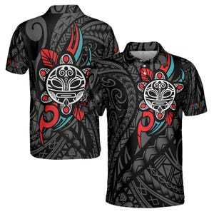 May include: A black and gray polo shirt with a Polynesian tribal design featuring a red and blue sun with a face. The shirt has short sleeves and a collar.