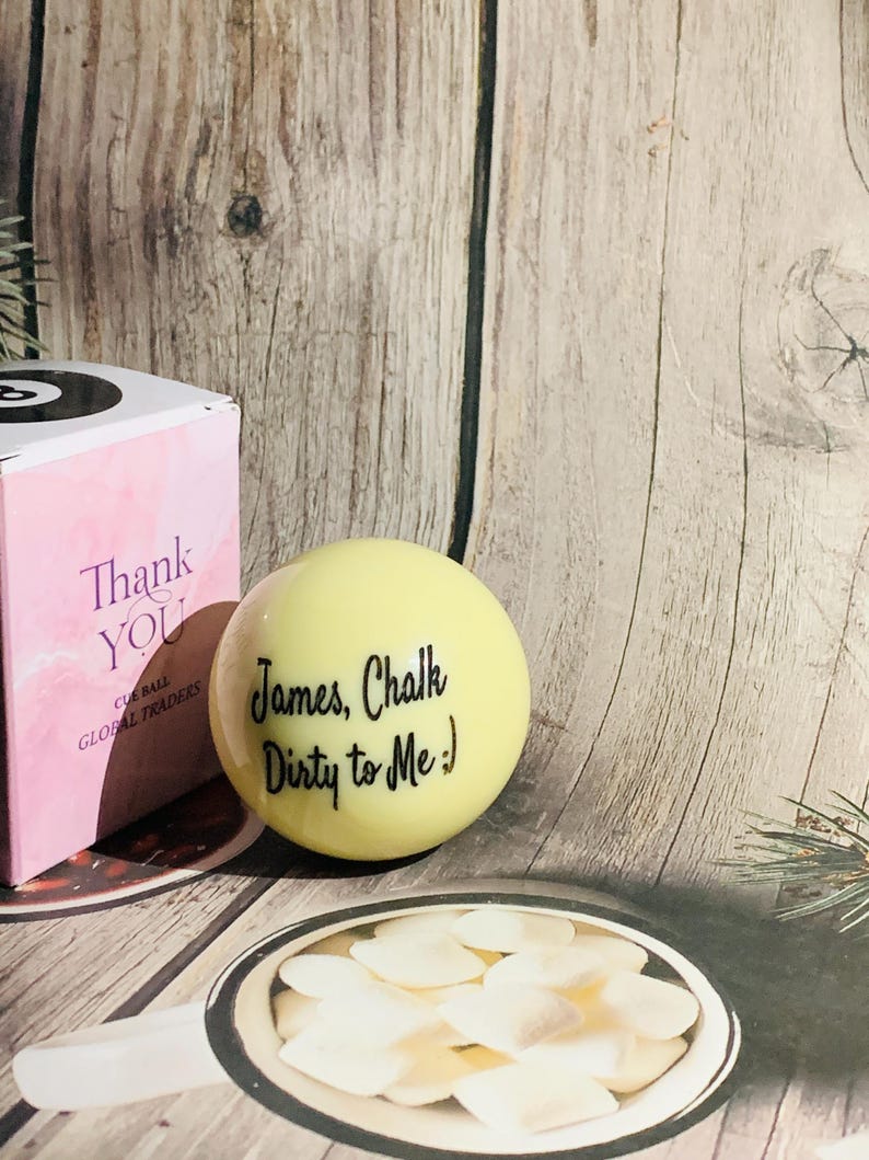 May include: A yellow cue ball with the text "James, Chalk Dirty to Me :)" written on it.