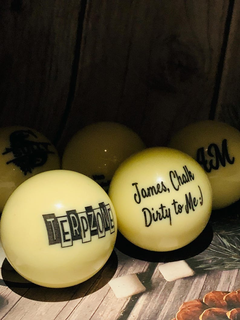 May include: Six yellow billiard balls with black lettering. The balls are arranged in a semi-circle. The text on the balls reads "TERPZONE", "James, Chalk Dirty to Me!" and "BM".