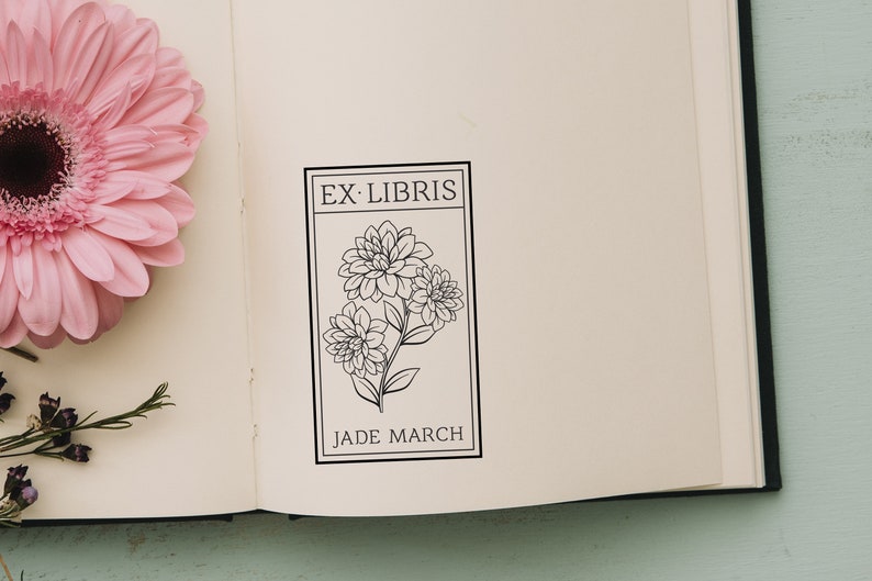 May include: A black and white bookplate with the text "Ex-Libris" and "Jade March" with a floral design of three stylized flowers.