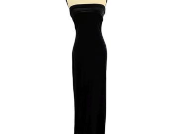 May include: A strapless, floor-length black velvet dress. The dress is displayed on a mannequin. The fabric appears to be soft and drapes smoothly. The dress has a simple, elegant design.