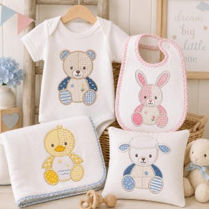 May include: A white baby bodysuit with a bear graphic, a white bib with a pink gingham trim and a rabbit graphic, a white blanket with a yellow duck graphic, and a white square pillow with a sheep graphic, all featuring patchwork-style designs.