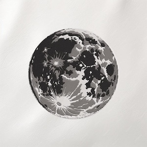 May include: A detailed black and white embroidered image of the moon. The design features craters and varying shades of gray, creating a textured, realistic depiction of the lunar surface. The moon is centered on a white background.