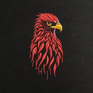 May include: Embroidered red eagle head on a black background. The eagle has a detailed design with red feathers, a yellow beak, and a focused expression. The embroidery is intricate, creating a textured appearance. The design is centered, making it a striking visual.