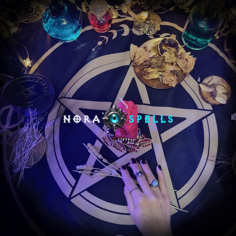 May include: A mystical scene featuring a dark blue cloth with a white pentagram design. Various potion bottles, dried herbs, and a red candle are arranged around the cloth. The text "NORA SPELLS" is visible. A hand with rings is also present.