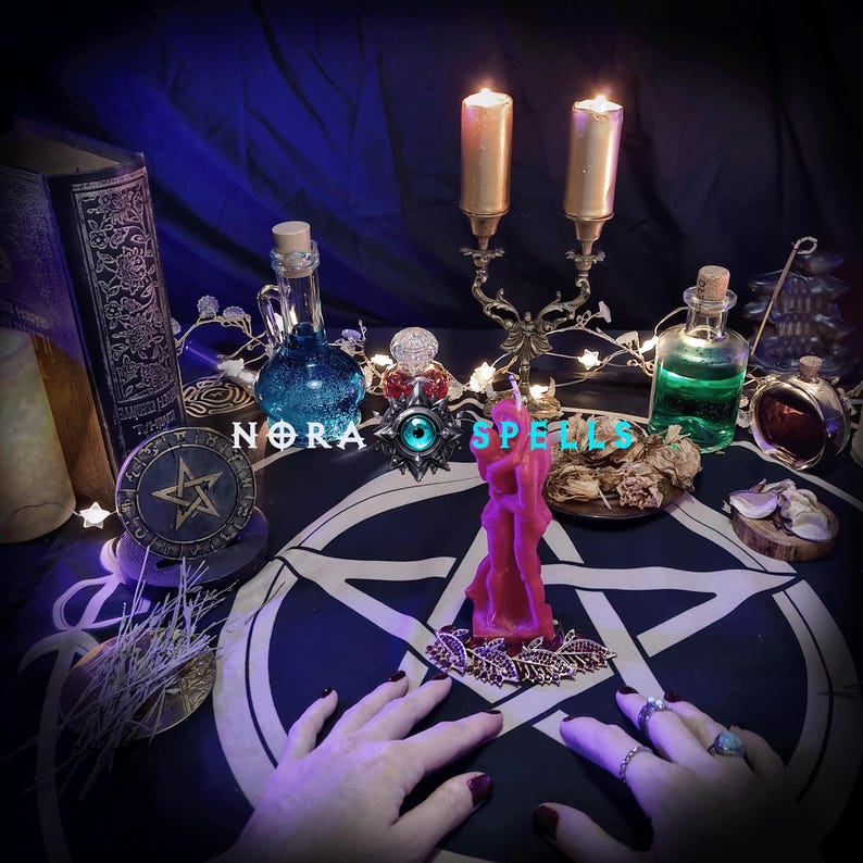 May include: A mystical scene featuring candles, potion bottles, and a pentagram. A pink candle shaped like two figures is in the center. The word "SPELLS" is visible. The scene is set on a dark blue cloth.