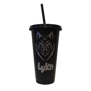 May include: Black tumbler with a black lid and straw. The tumbler features a silver wolf head design and the word "Lykn" in silver lettering. The tumbler is designed to hold cold beverages.