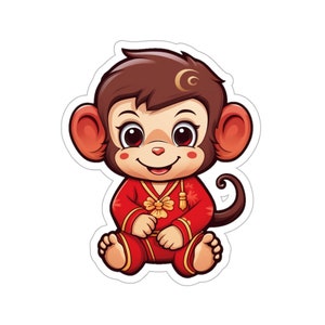 Puede incluir: Una ilustración de dibujos animados de un mono con un atuendo chino de Año Nuevo rojo y dorado. El mono está sentado con las piernas cruzadas y tiene una expresión feliz en su rostro.