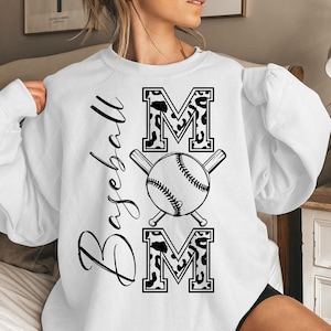 May include: White sweatshirt with the words "Baseball Mom" in black script. The word "MOM" is in a bold, leopard print font, with a baseball and crossed bats in the center.