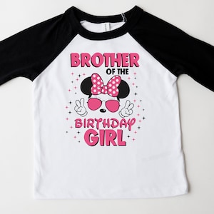 May include: White and black raglan-sleeve t-shirt with a graphic that says "Brother of the Birthday Girl." The graphic features a cartoon mouse wearing sunglasses and a polka-dot bow. The shirt is designed for a child.