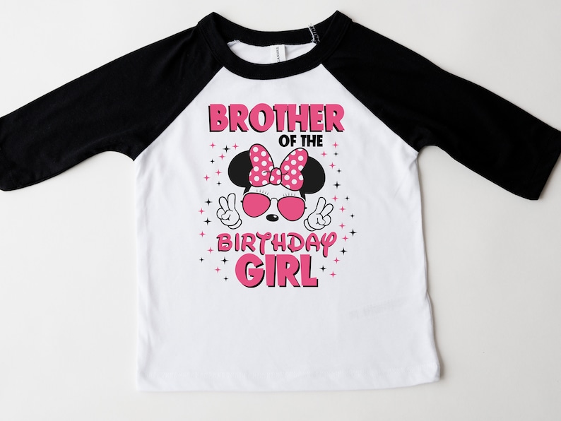 May include: White and black raglan-sleeve t-shirt with a graphic that says "Brother of the Birthday Girl." The graphic features a cartoon mouse wearing sunglasses and a polka-dot bow. The shirt is designed for a child.