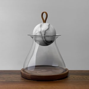 May include: A handmade wooden sign with the text "Welcome" in a playful font. The sign is painted white with a distressed finish, and features a decorative floral design in shades of pink and green. It measures approximately 12 inches wide and 6 inches tall.