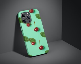 以下が含まれることがあります： ミントグリーンの携帯電話ケースに、赤いチェリーと緑の葉の模様が描かれています。