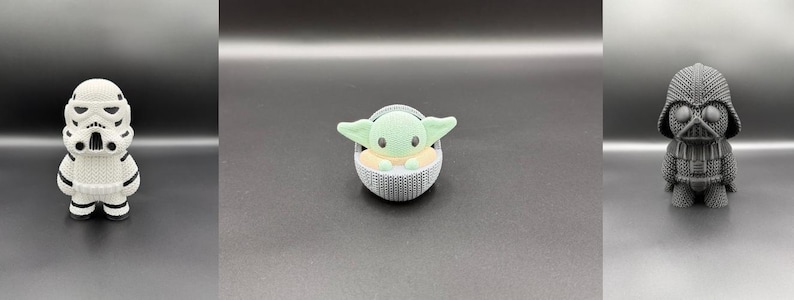 May include: Three Star Wars character figurines: a white Stormtrooper, a green Grogu in a gray carrier, and a gray Darth Vader. Each figure has a unique design and stands on a dark surface. The figurines are approximately 3 inches tall.