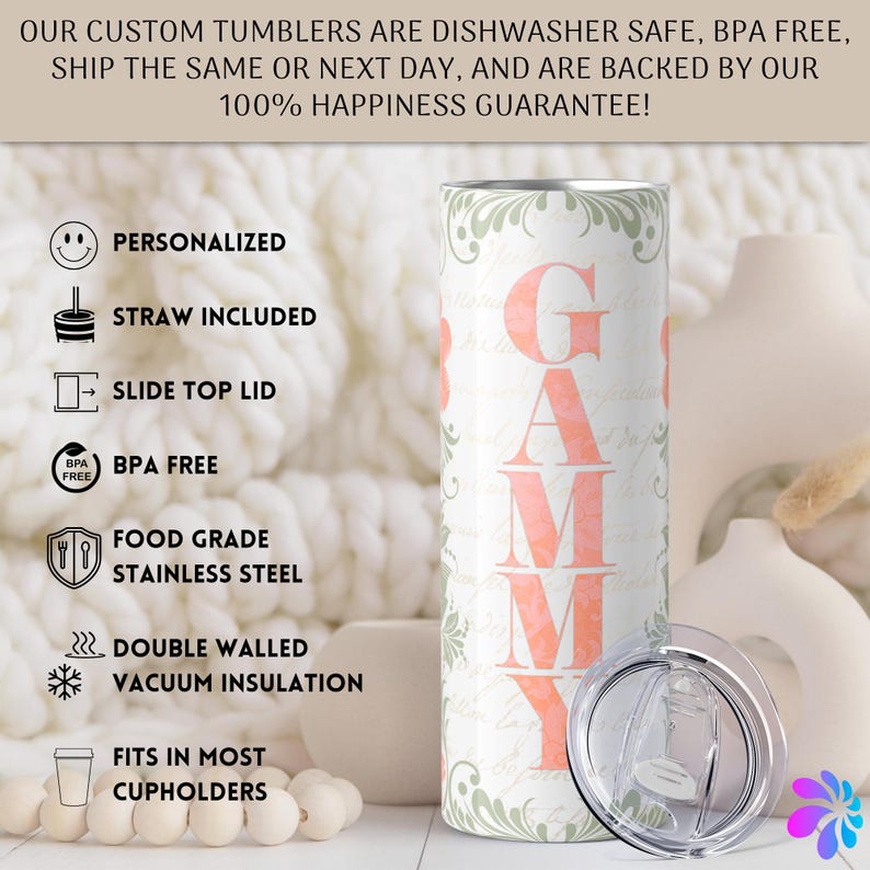 May include: A white stainless steel tumbler with a pink and green floral design and the word "GAMMY" in pink letters. The tumbler has a clear lid with a slide top.