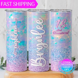 May include: Three stainless steel tumblers with a glittery iridescent finish. The tumblers feature different designs: one says "eighteen", one says "Brianne", and one says "18 And Glamorous!"