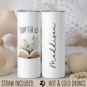 May include: White insulated tumbler with a straw, featuring the text "CHAPTER 65" above an open book with floral illustrations. The other tumbler has the name "Madison" in cursive. The words "STRAW INCLUDED" and "HOT & COLD DRINKS" are also visible.