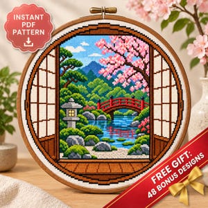 Könnte beinhalten: Ein runder Stickrahmen mit einem Kreuzstichmotiv eines japanischen Gartens, das eine rote Bogenbrücke, eine Steinlaterne, Kirschblüten und einen Berg zeigt, eingerahmt von hölzernen Shoji-Türen und Fenstern.