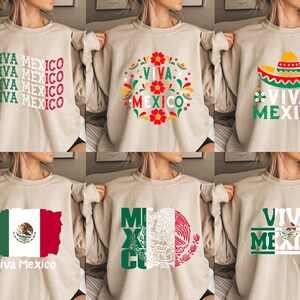 May include: Six different designs of beige sweatshirts with various Mexican-themed graphics. The designs include the words "Viva Mexico" in different fonts and styles, a sombrero, and the Mexican flag.