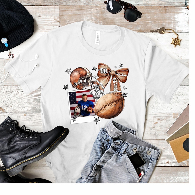 May include: White t-shirt with a football helmet, football, and a bow with the text "Davis" on it. A photo of a young boy wearing a football uniform is in the corner of the shirt.