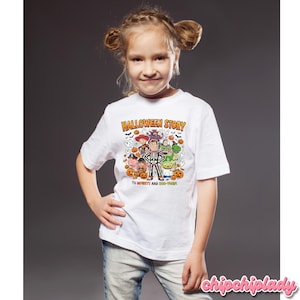 May include: A white t-shirt featuring a colorful Halloween-themed graphic with the text "HALLOWEEN STORY" and "TO INFINITY AND BOO-YOND". The design includes cartoon characters, pumpkins, ghosts, and bats.