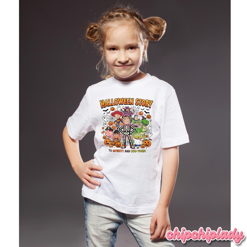 May include: A white t-shirt featuring a colorful Halloween-themed graphic with the text "HALLOWEEN STORY" and "TO INFINITY AND BOO-YOND". The design includes cartoon characters, pumpkins, ghosts, and bats.