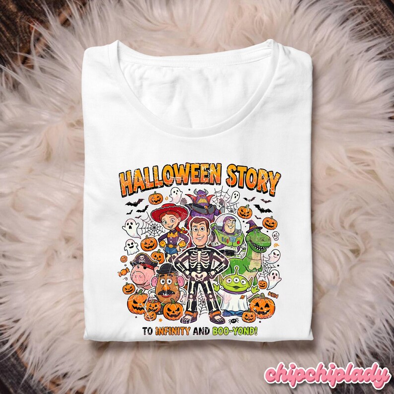 May include: White t-shirt with a Halloween-themed graphic featuring cartoon characters, pumpkins, ghosts, and bats. The text "HALLOWEEN STORY" and "TO INFINITY AND BOO-YOND!" are printed on the shirt. The shirt is displayed on a fluffy, white surface.